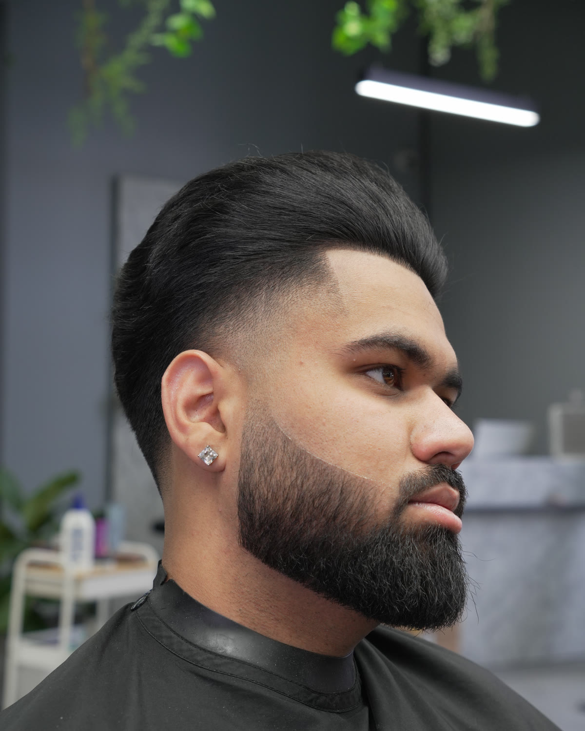 A precise skin fade and sculpted beard at Artistly