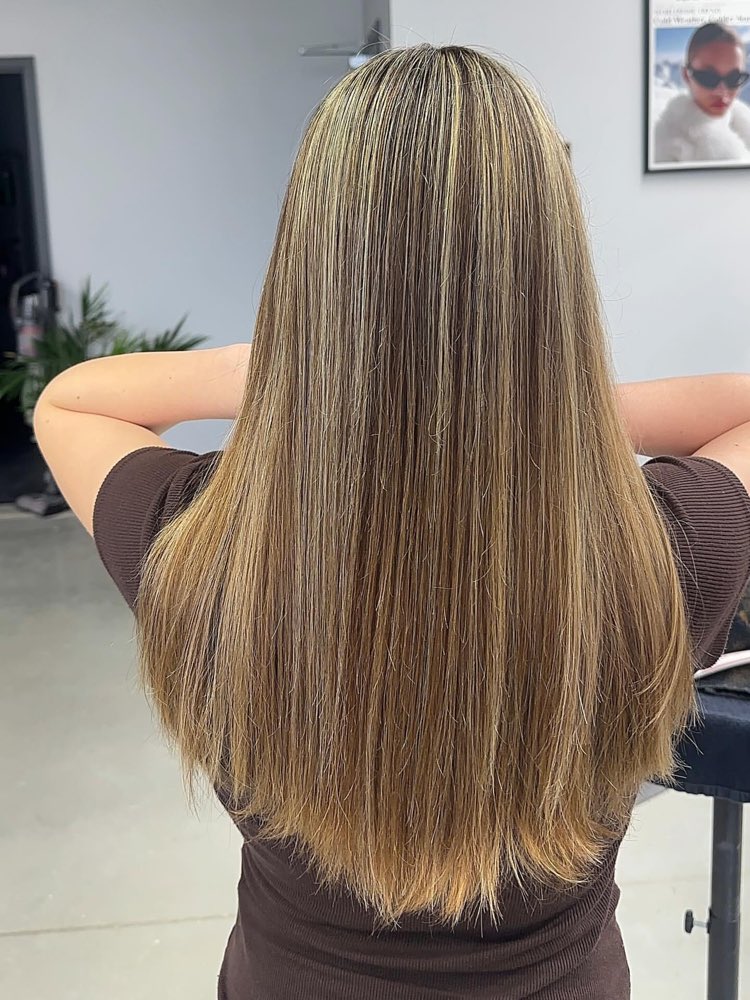 Blonde balayage on long straight hair at Artistly