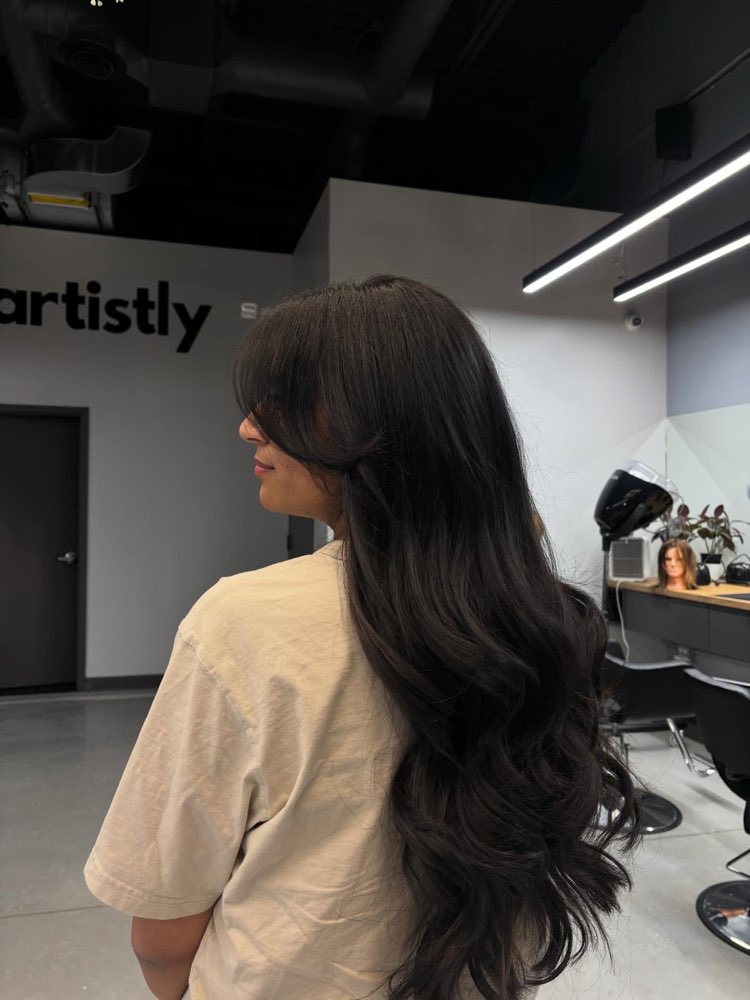 Long layers and curtain bangs cut at Artistly